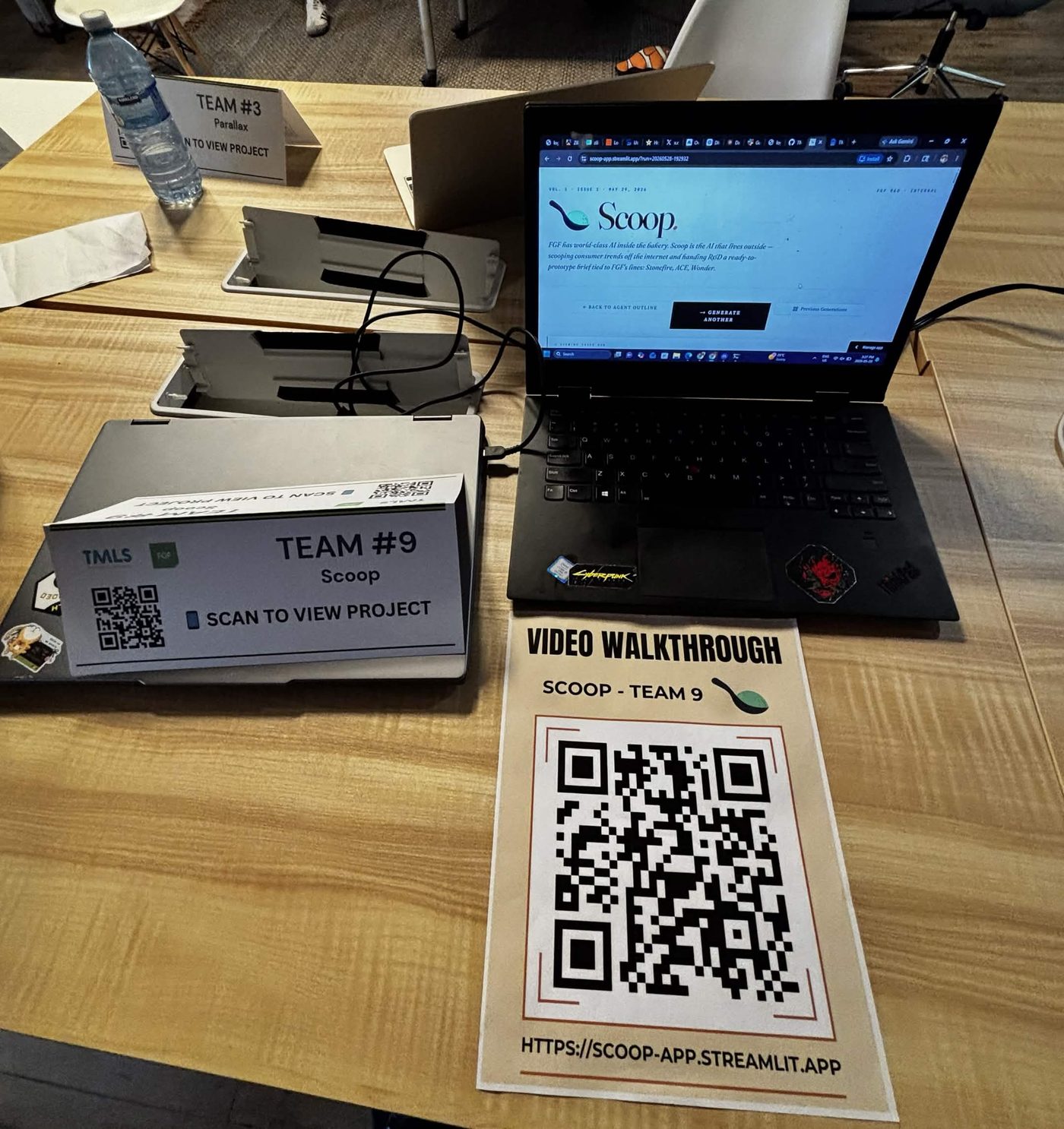 Scoop demo table at the expo with QR codes for the app and video walkthrough